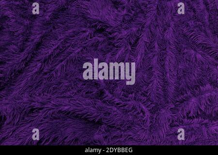 abstract background of detail bright pattern texture shaggy fur with long fibers. Polyester synthetic or natural fluffy plaid. Comfortable home textil Stock Photo