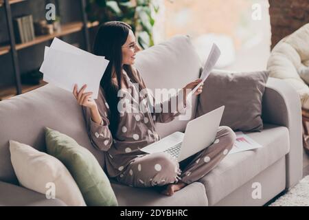 Profile photo of nice optimistic girl sit look papers laptop wear spectacles pijama at home Stock Photo