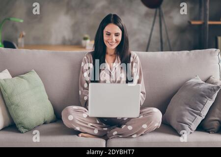 Photo of nice optimistic girl sit write laptop wear pijama at home Stock Photo