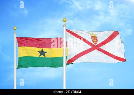 Ghana and Jersey two flags on flagpoles and blue sky Stock Photo