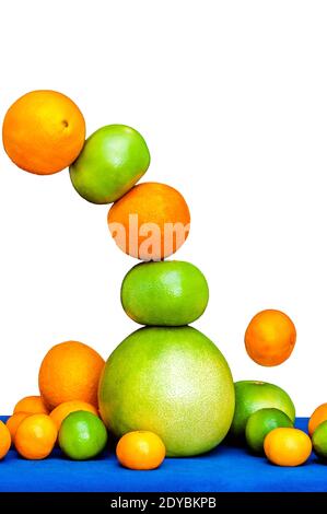 Falling tower of citruses, oranges, pomelo, limes, tangerines and grapefruits isolated on white background Stock Photo
