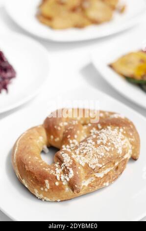 vegan dairy-free organic german traditional pretzel bread on white table Stock Photo