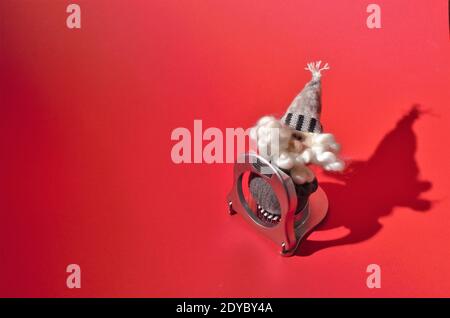 Minimal festive concept: Santa Claus trapped in an egg slicer Stock Photo