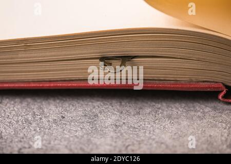 A old beautiful heart key with lays between the pages of a old book. Stock Photo