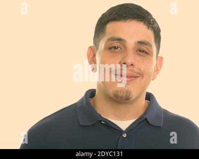 Close up of young Hispanic man smiling and looking at camera Stock Photo