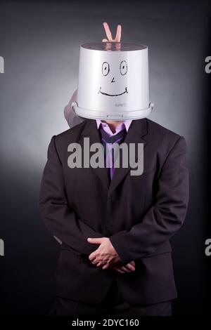 funny businessman with a bucket on his head Stock Photo