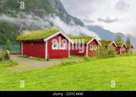 Traditional Norwegian red houses with a turf roof. Old farm hotel near Lake - norway Stock Photo