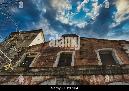 abandoned factory with dramatic cloud sky in spain Stock Photo