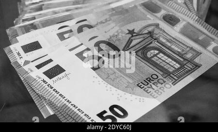 Big paper money pile of 50 euro bills or banknotes. Lots of money or currency. Money and finance. Concept of being or getting rich. Black and white ph Stock Photo