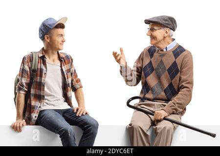 Guy sitting on a panel and listening to an elderly man talking isolated on white background Stock Photo