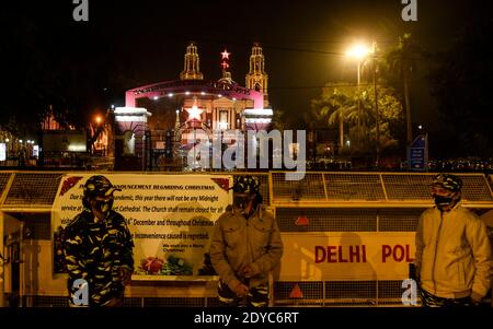 New Delhi, India. 25th Dec, 2020. Delhi police outside the barricade of Sacred Heart Cathedral on the occasion of Christmas celebrations, amidst the spread of the coronavirus disease (COVID-19), in New Delhi on December 25, 2020. Delhi's biggest church, the Sacred Heart Cathedral, reemained shut on Christmas for the very first time ever in wake of the coronavirus. Credit: David Talukdar/ZUMA Wire/Alamy Live News Stock Photo