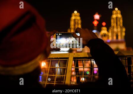 New Delhi, India. 25th Dec, 2020. A man takes photo of the Sacred Heart Cathedral from outside the barricade, on the occasion of Christmas celebrations, amidst the spread of the coronavirus disease (COVID-19), in New Delhi on December 25, 2020. Delhi's biggest church, the Sacred Heart Cathedral, reemained shut on Christmas for the very first time ever in wake of the coronavirus. Credit: David Talukdar/ZUMA Wire/Alamy Live News Stock Photo
