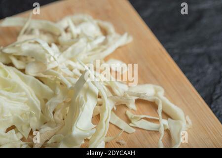 Chopped white cabbage on the wooden cutting board Stock Photo