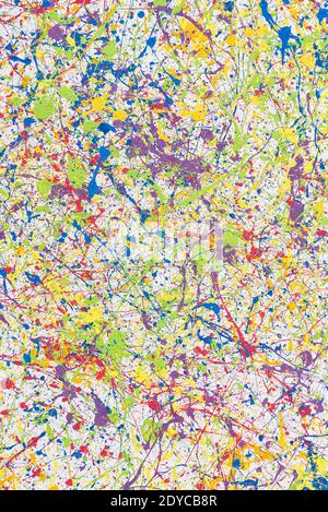 Wall with multi-colored paint splashes. Bright abstract background. Vertical frame. Stock Photo