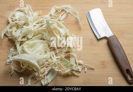 Close up photo of chopped cabbage in wooden background Stock Photo