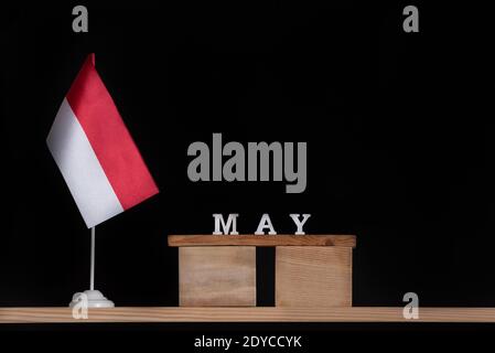 Wooden calendar of May with Polish flag on black background. Holidays of Poland in May Stock Photo