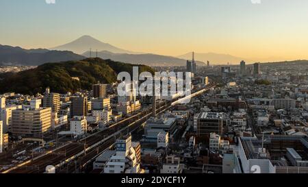 Mt Fuji at sunrise with railway lines and Shinkansen, Shizuoka, Japan Stock Photo