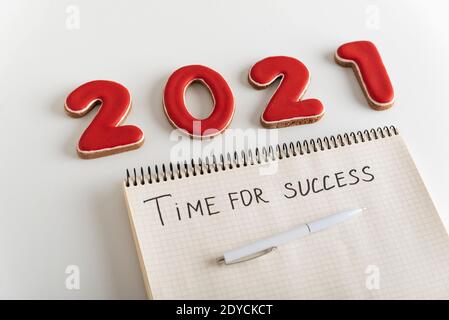 Figures 2021 and blank notebook on page with pen it is written: TIME FOR SUCCESS Stock Photo
