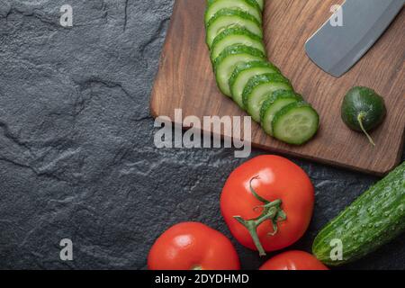 Sliced cucumber and tomato on black background Stock Photo