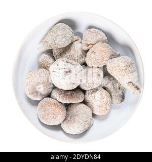 Dried figs in a white ceramic bowl. Dried fruit with copy space for text. Top view. Figs isolated on white background. Stock Photo