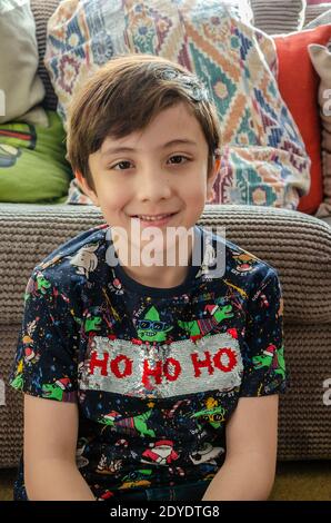 Portrait of a handsome, young boy, smiling and looking at the camera with brown hair and brown eyes. Stock Photo