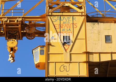 Serge Charnay stands on a giant crane disused on February 17, 2013 in Nantes on the third day of a protest for his rights as a father. He paints the message ' Save out children from the justice'. Photo by Laetitia Notarianni/ABACAPRESS.COM Stock Photo