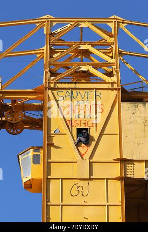 Serge Charnay stands on a giant crane disused on February 17, 2013 in Nantes on the third day of a protest for his rights as a father. He paints the message ' Save out children from the justice'. Photo by Laetitia Notarianni/ABACAPRESS.COM Stock Photo