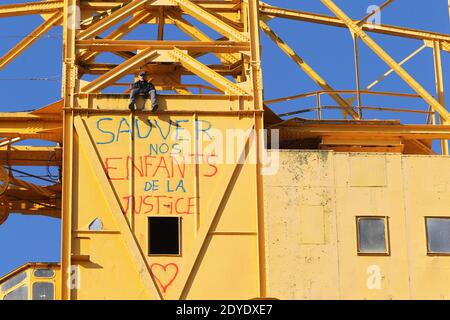 Serge Charnay stands on a giant crane disused on February 17, 2013 in Nantes on the third day of a protest for his rights as a father. He paints the message ' Save out children from the justice'. Photo by Laetitia Notarianni/ABACAPRESS.COM Stock Photo