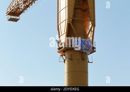 Serge Charnay stands on a giant crane disused on February 17, 2013 in Nantes on the third day of a protest for his rights as a father. He paints the message ' Save out children from the justice'. Photo by Laetitia Notarianni/ABACAPRESS.COM Stock Photo