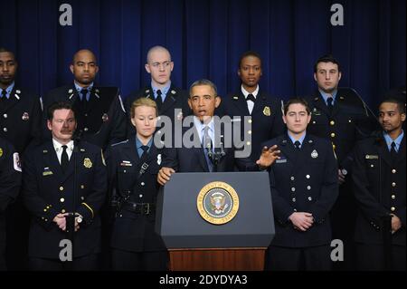 U S President Barack Obama C Is Surrounded By Lawmakers And Family Members Of Slain Police Officers As He Signs The Rafael Ramos And Wenjian Liu National Blue Alert Act Into Law In