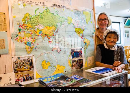 "The world as a guest in the village": at the end of a cooking workshop, Angela Berg and Sumiko Sano get to place a pin on the world map at the restaurant in the village of Yuno near Fujinomiya, Japan. Stock Photo