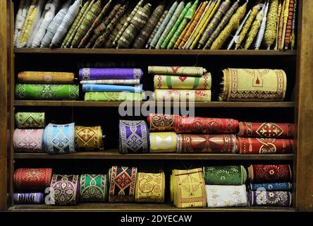 The tiny, old-fashioned shop 'Gammarelli' in downtown Rome, Italy displayed on March 4, 2013 the three sets of white vestments to be shipped to the Vatican for the new pope. Here have been made three versions, small, medium and large of the white vestments the new pope will wear when he first appears to the world. 'Gammarelli', as the ecclesiastical fashion house is known, has dressed the spiritual leaders of the Roman Catholic Church since 1798. 'We have prepared three vestments in white wool, a stole, red loafers, a skullcap, as well as a red velvet cape with a white fur border since it's wi Stock Photo