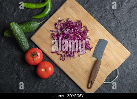 Vegetables mix. chopped cabbage, cucumber, tomato and pper on black background Stock Photo