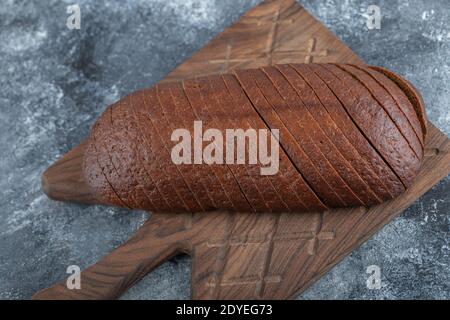 Homemade Organic Pumpernickel Rye Bread on Wooden cutting board Stock Photo
