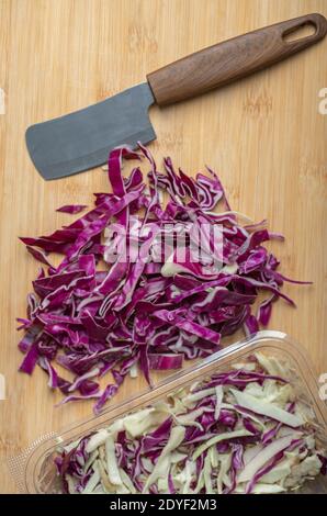 Chopped Cabbage on the wood board with knife Stock Photo