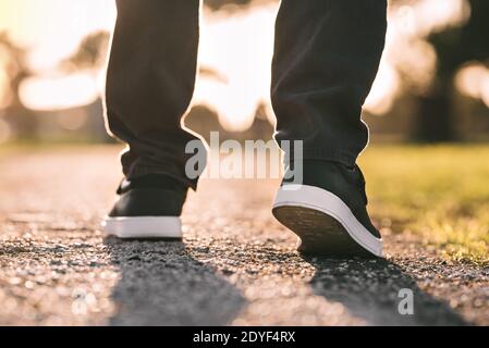 Close up of walking man. Walking outdoors. Closeup on shoe, taking a step Stock Photo