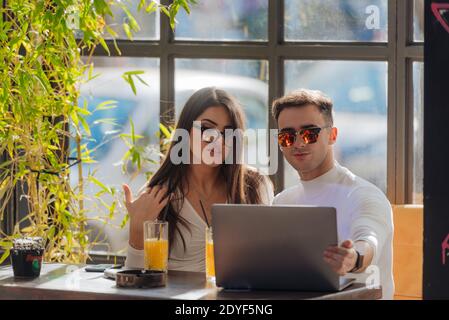 Co-workers spending time together on a break while working on a project on a lovely sunny day. Stock Photo