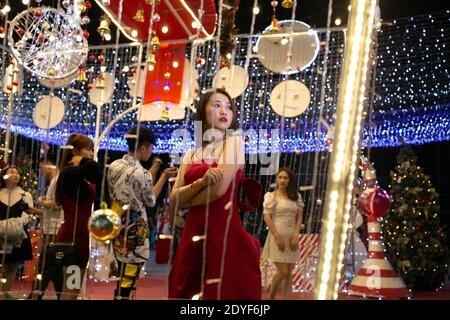 Vientiane, Laos. 24th Dec, 2020. People take photos in front of Christmas decorations in Vientiane, Laos, Dec. 24, 2020. Credit: Kaikeo Saiyasane/Xinhua/Alamy Live News Stock Photo