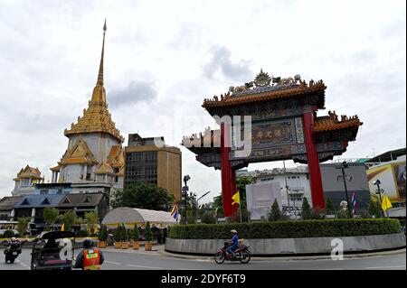 View of Chinatown Gate and Wat Traimit, Yaowarat, Bangkok. The ornate gate was inaugurated in 1999 to celebrate the King’s 60th year on the throne.