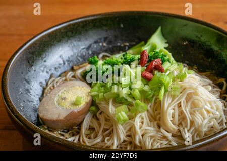 The close up of Taiwan homemade thin noodles with sesame oil, Taiwanese traditional famous food on wooden table. Stock Photo