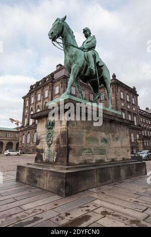 Copenhagen, Denmark - December 10, 2017: The equestrian statue of Christian IX, overlooking Christiansborg Ridebane on Slotsholmen, was created by Ann Stock Photo