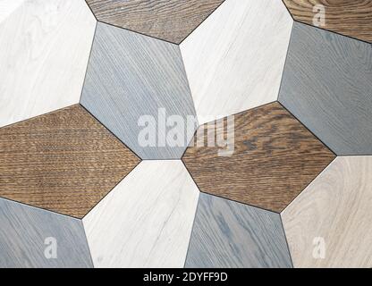 Decorative panel made of wooden multi-colored polygons. Stock Photo