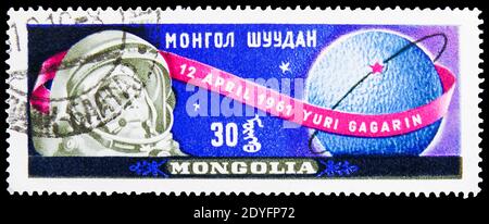 MOSCOW, RUSSIA - JUNE 19, 2019: Postage stamp printed in Mongolia shows Gagarin and Globe, Yuri Gagarin, First Man in Space serie, circa 1961 Stock Photo