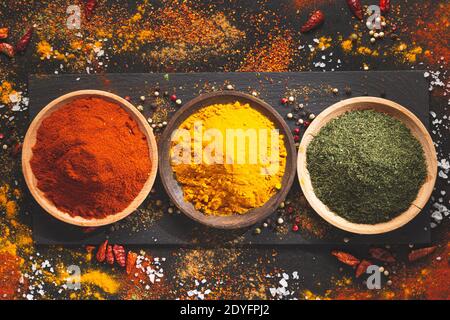 Various spices on a black background, top view. Condiments of cooking concept. Stock Photo