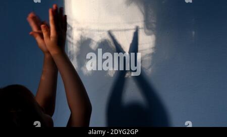 Child claps hands on unfocused foreground and focus to blurry hand ...