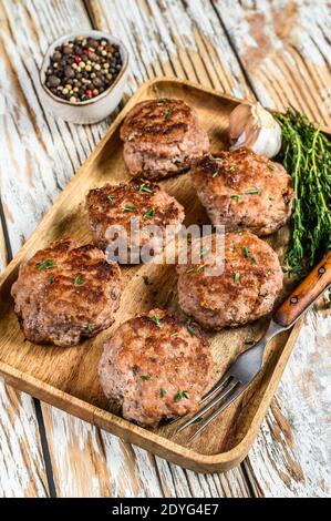 Fried meat chicken cutlets on a wooden tray. White background. Top view Stock Photo