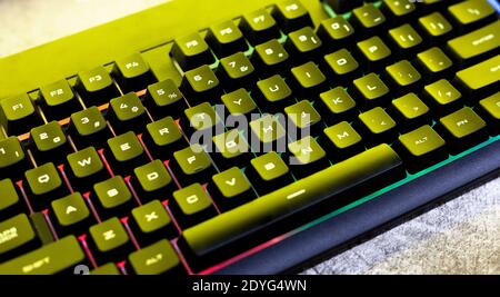 Simple modern rgb backlit gaming mechanical keyboard surface, computer keys closeup, from above, top view, angle. PC keyboard backlight technology Stock Photo