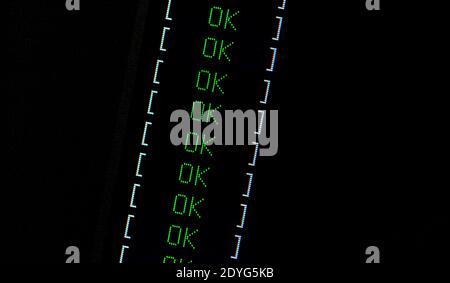 OK text on dark computer screen, task successful, system check completed, check list passed, computing positive outcome computation success Stock Photo