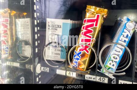 Protective three layer medical face mask inside a food vending machine beside snacks, closeup Selling masks, covid 19 corona virus protection Stock Photo