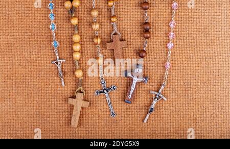 Lots of simple Christian rosaries, multiple crosses, many catholic symbols, objects group. Christianity symbolic, catholicism, religion and faith Stock Photo